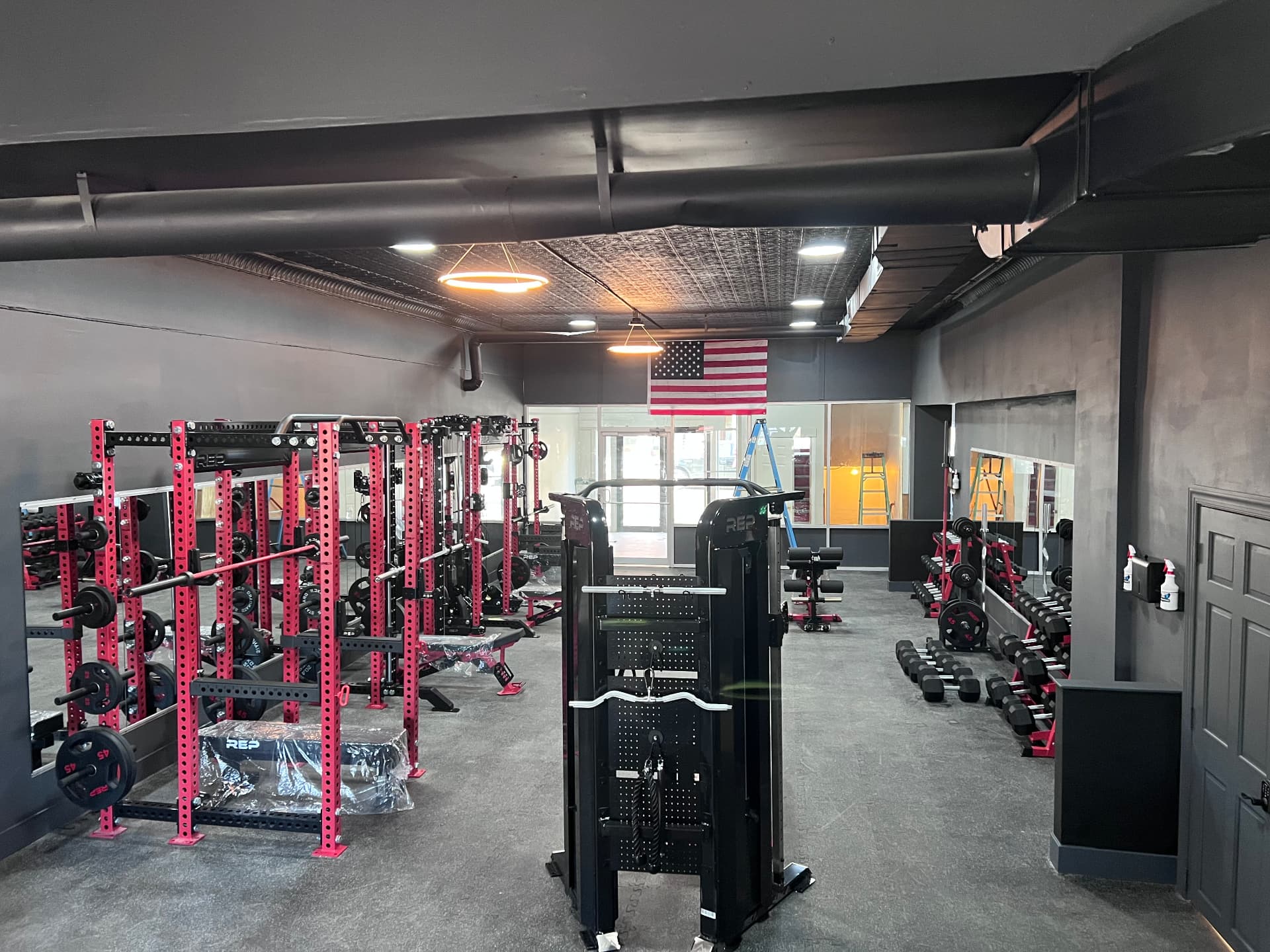 Metamorphosis Gym gym floor with strength equipment and American flag